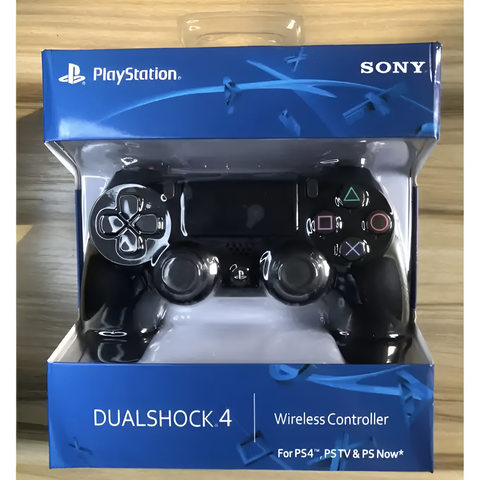 PlayStation DualShock 4 wireless controller packaging with Sony branding on a wooden surface.