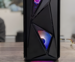 Glossy black computer case with colorful LED lights on a wooden surface