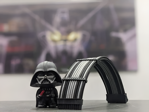 Small Darth Vader figure next to a metal cable arch on a blurred background