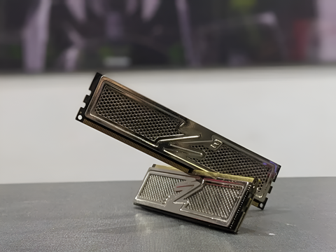 Metallic computer memory module on a reflective surface with a blurred background