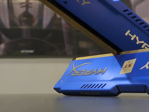 Close-up of a blue and gold computer memory module with HyperX branding.