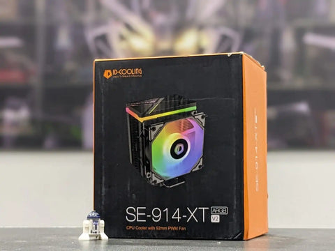 CPU cooler packaging with colorful fan design on a blurred background