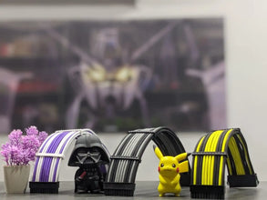 Toy figures of Darth Vader and Pikachu standing under a small archway with a blurred superhero background.