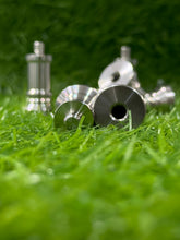 Metallic golf club heads on grass