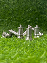 Metal chess pieces on a grassy background