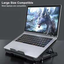 Laptop on a cooling stand with a dragon graphic on the screen, on a dark background.