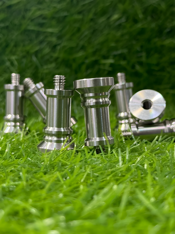 Metal screws on a grassy background