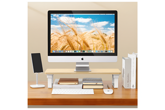 Computer setup on a desk with a monitor displaying a wheat field image.