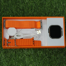 Smartwatch with accessories in an open box on grass