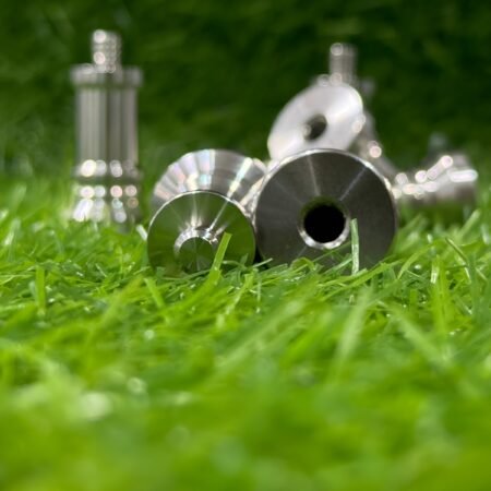 Metallic golf club heads on grass