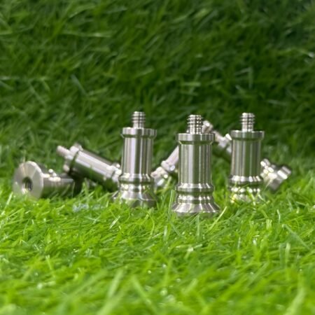 Metal chess pieces on a grassy background