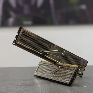 Metallic computer memory module on a reflective surface with a blurred background
