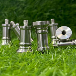 Metal screws on a grassy background