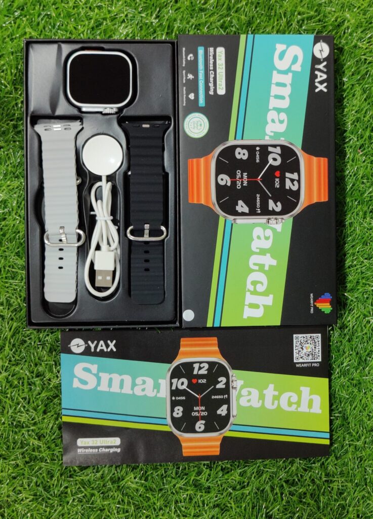 YAX smartwatch set with packaging on a grass background